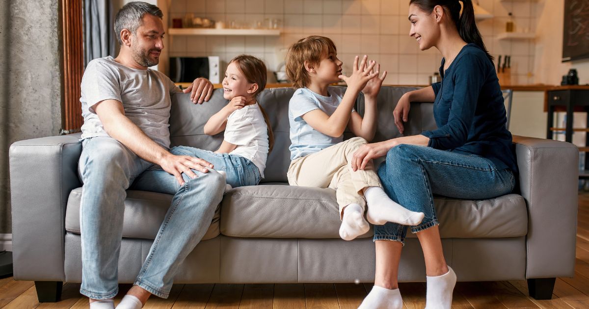 parents with kids sitting on sofa