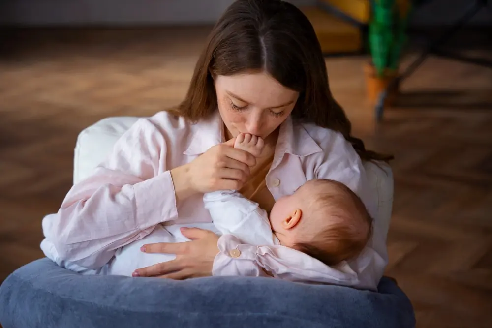 Mom kissing her newborn