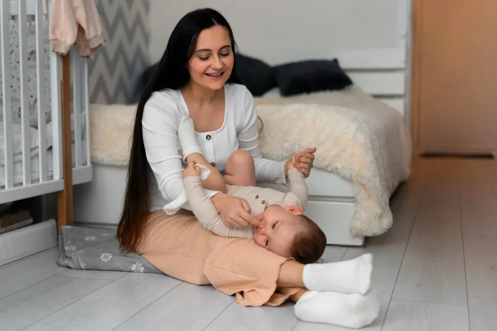 Mother nurturing her baby on floor.