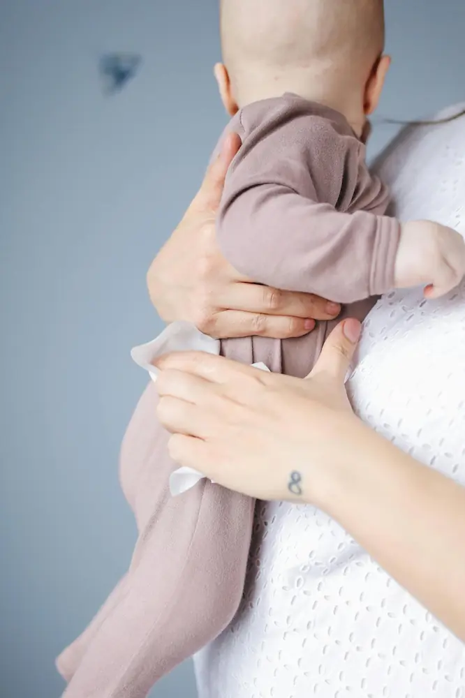 Mother holding baby in soft clothing