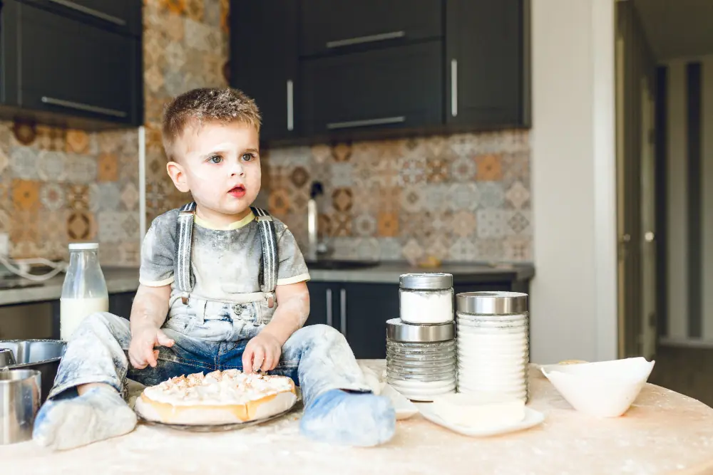 Baby in kitchen creating mess in kitchen