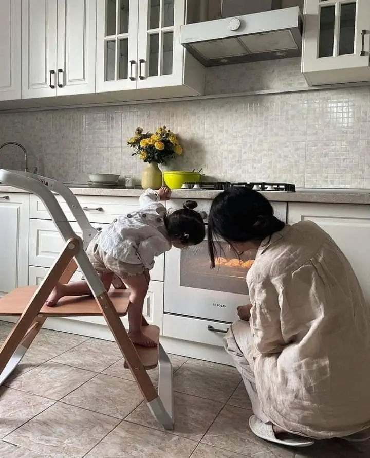 Mother and child in kitchen together.