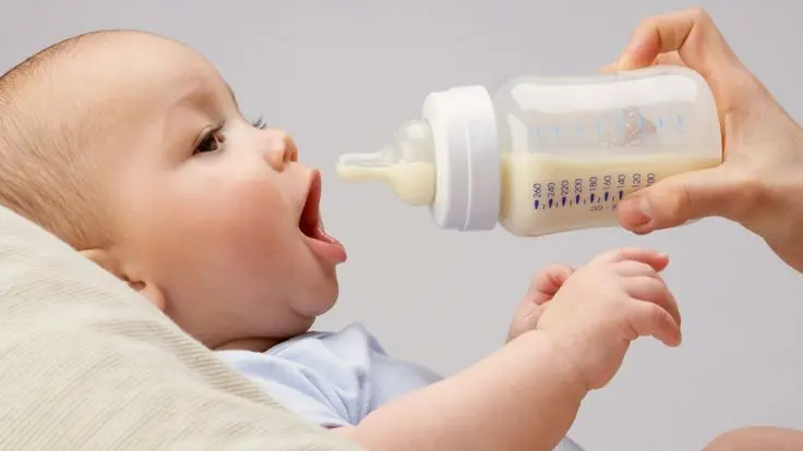 Baby drinking milk from bottle