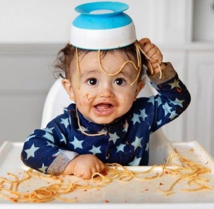 Baby is doing mess with his food