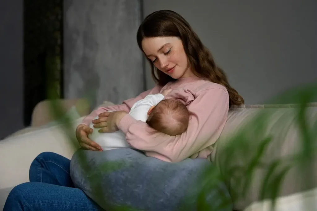 new mom with her new born doing breastfeeding